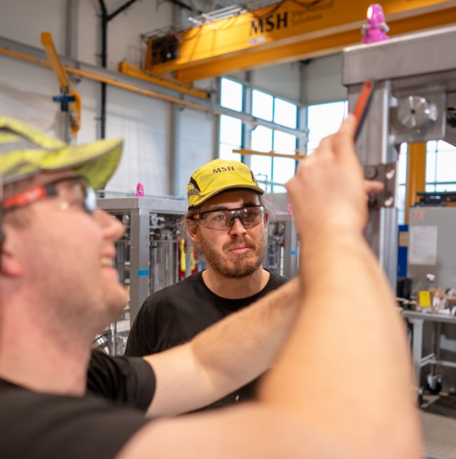 Two MSH technicians inspecting equipment in the workshop